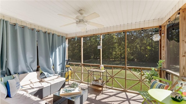 sunroom featuring ceiling fan