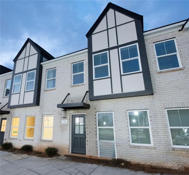 rear view of house with brick siding