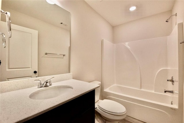 bathroom with shower / washtub combination, toilet, and vanity