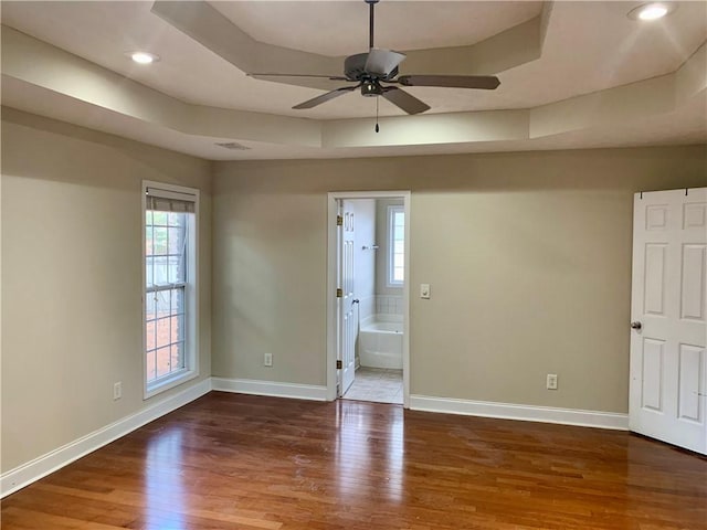 3672 Hawthorne Ct, Auburn, AL 36830 - unfurnished room featuring a raised ceiling, a ceiling fan, wood finished floors, plenty of natural light, and recessed lighting