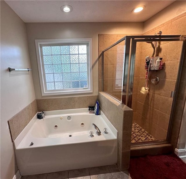 3672 Hawthorne Ct, Auburn, AL 36830 - bathroom featuring a jetted tub, a stall shower, and tile patterned floors