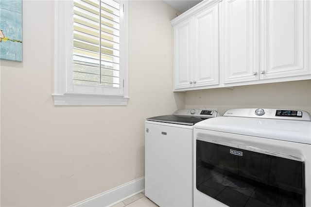 554 Arbor Dr, Auburn, AL 36830 - laundry area with washer and dryer, cabinet space, and light tile patterned flooring