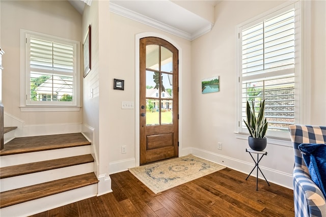 554 Arbor Dr, Auburn, AL 36830 - entrance foyer featuring dark wood-style flooring, stairs, crown molding, and arched walkways