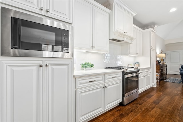 554 Arbor Dr, Auburn, AL 36830 - kitchen featuring gas range, black microwave, dark wood-style flooring, light countertops, and white cabinets