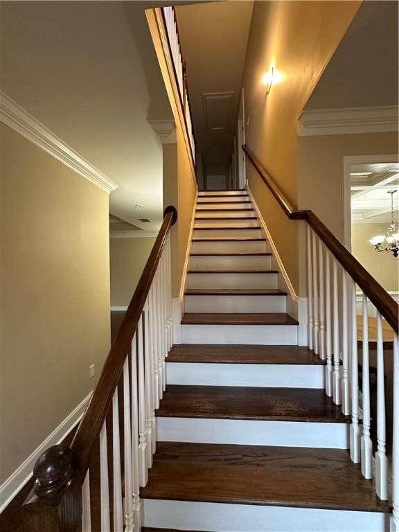 stairway featuring crown molding and a chandelier