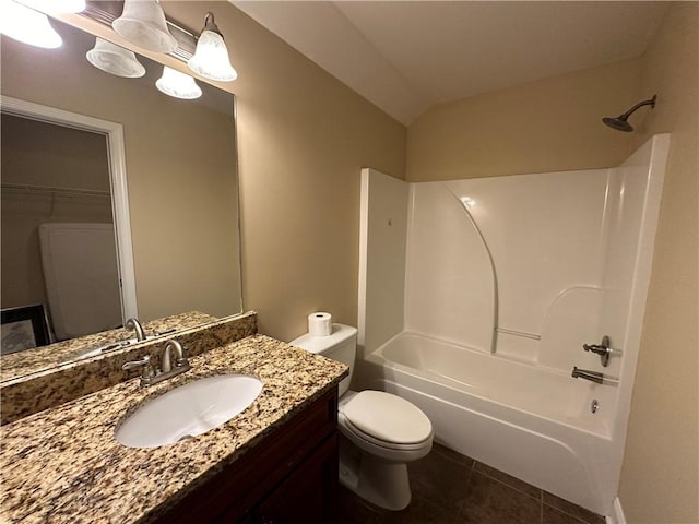 full bathroom featuring tile patterned floors, vaulted ceiling, toilet, shower / washtub combination, and vanity