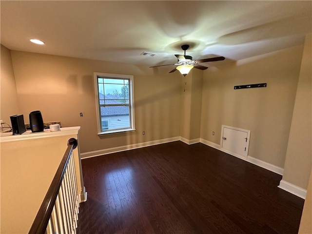 spare room with ceiling fan and dark hardwood / wood-style flooring