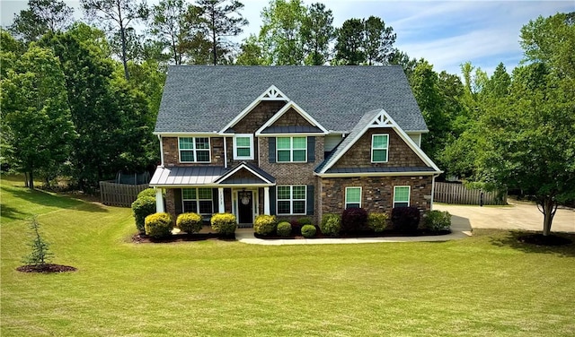 craftsman inspired home with covered porch, a standing seam roof, and stone siding
