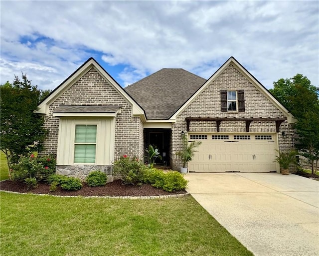 2457 Snowshill Ln, Auburn, AL 36832 - view of front of home with brick siding, concrete driveway, a front lawn, and a shingled roof