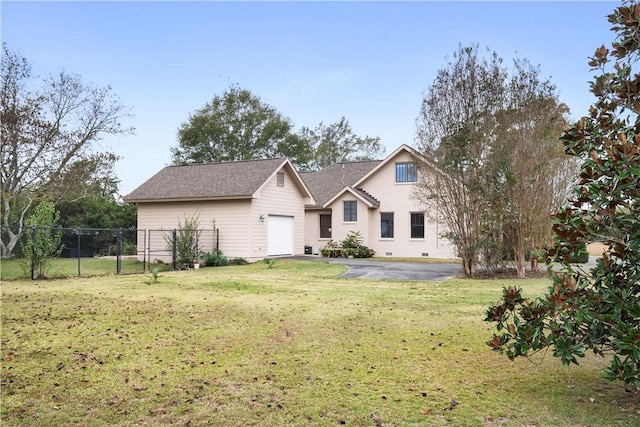 view of front facade with a front yard and a garage