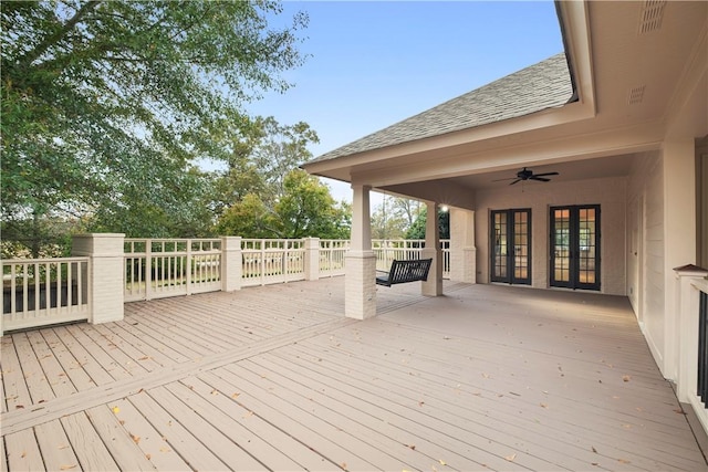 wooden terrace with ceiling fan and french doors