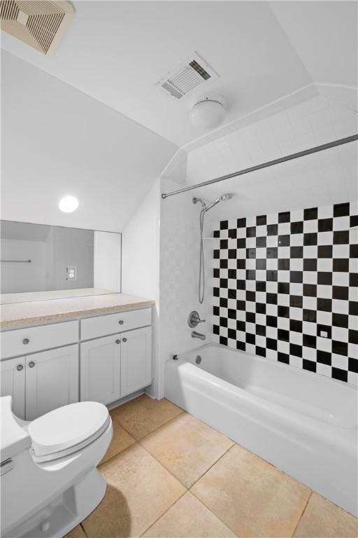 full bathroom with tile patterned floors, vanity, tiled shower / bath combo, and toilet