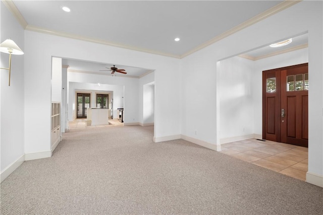 carpeted entryway with crown molding and ceiling fan