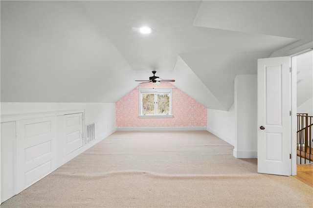 bonus room with ceiling fan, light carpet, and lofted ceiling