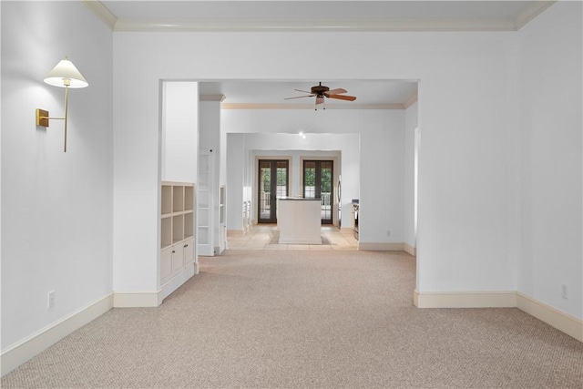 empty room with light carpet, french doors, ceiling fan, and ornamental molding