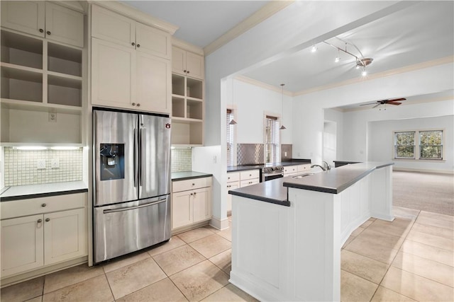 kitchen with ceiling fan, light colored carpet, decorative backsplash, and appliances with stainless steel finishes