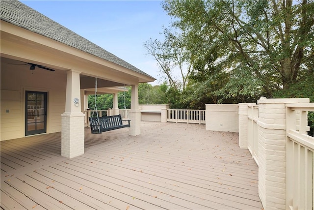 wooden deck featuring ceiling fan