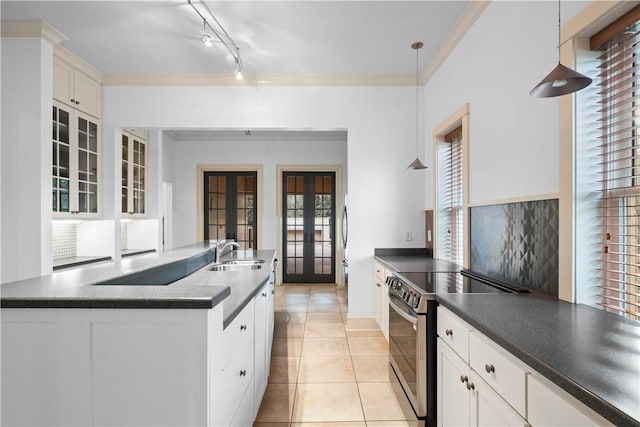 kitchen featuring french doors, white cabinets, pendant lighting, and stainless steel range with electric stovetop