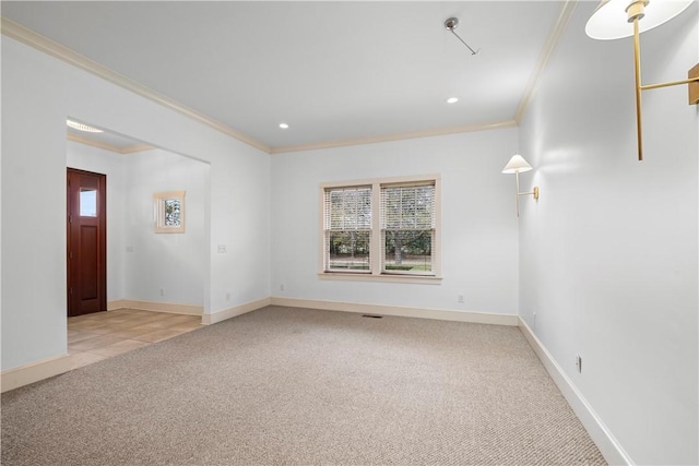 spare room with crown molding and light colored carpet