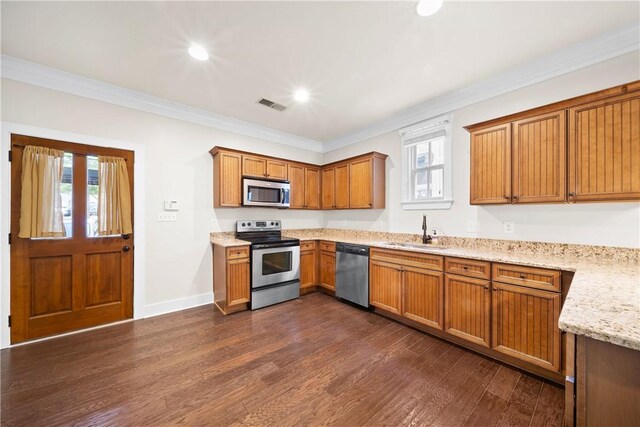 650 Dekalb St Unit 1130, Auburn, AL 36830 - kitchen featuring stainless steel appliances, dark wood-type flooring, brown cabinets, crown molding, and healthy amount of natural light