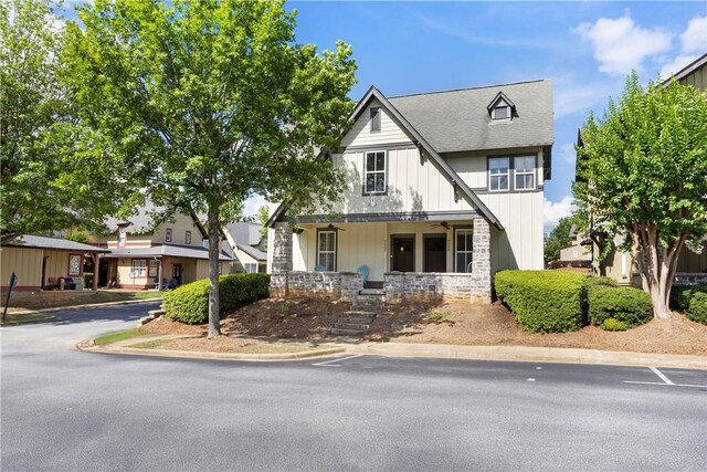 650 Dekalb St Unit 1130, Auburn, AL 36830 - view of front facade featuring covered porch, board and batten siding, stairway, a shingled roof, and stone siding