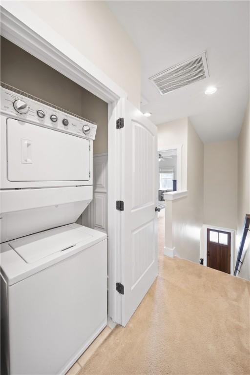 650 Dekalb St Unit 1130, Auburn, AL 36830 - laundry area with stacked washing machine and dryer and light carpet