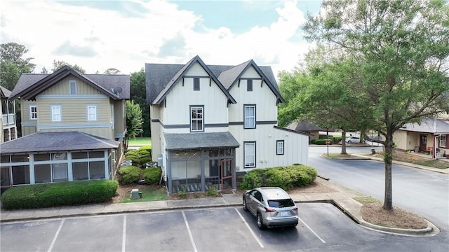 650 Dekalb St Unit 1130, Auburn, AL 36830 - view of front facade with roof with shingles, uncovered parking, board and batten siding, and a sunroom