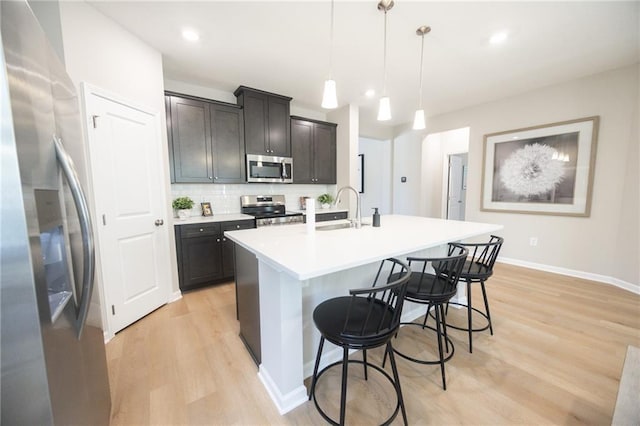 361 Lee Rd Unit 2232, Lot20, Cusseta, AL 36852 - kitchen with a kitchen bar, appliances with stainless steel finishes, a center island with sink, light wood-type flooring, and a sink