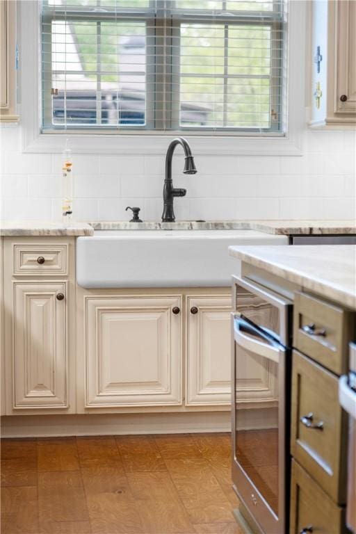 bathroom featuring tasteful backsplash, plenty of natural light, and a sink