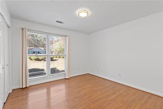 empty room with hardwood / wood-style flooring