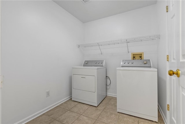 washroom with washer and dryer and light tile patterned floors