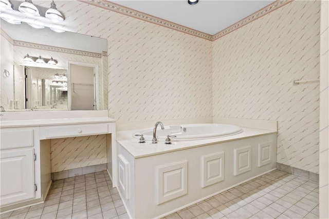 bathroom featuring tile patterned floors, a washtub, and vanity