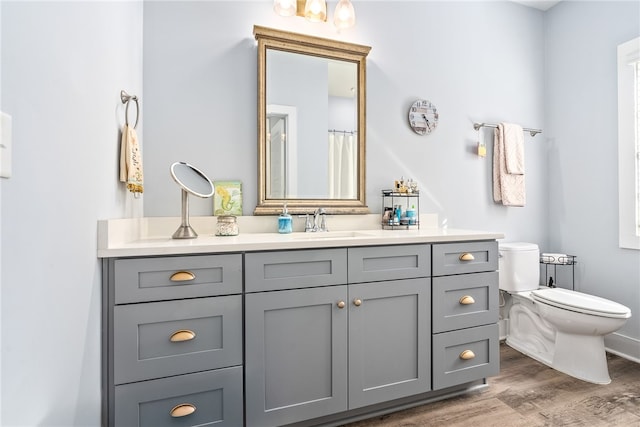 1242 Burrow Cir, Opelika, AL 36801 - full bath featuring vanity, toilet, wood finished floors, and baseboards