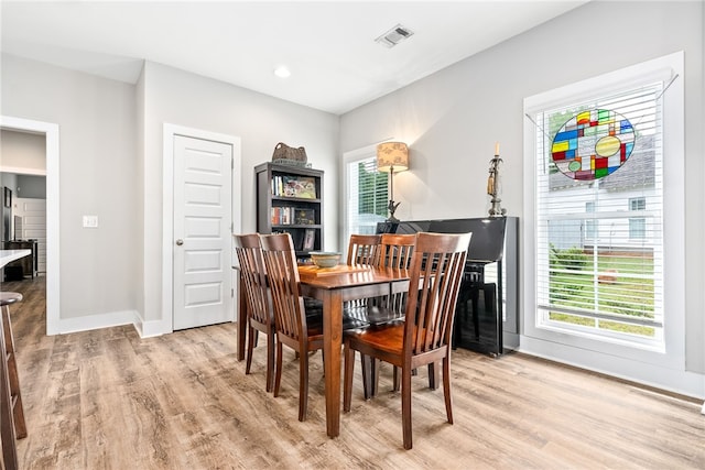 1242 Burrow Cir, Opelika, AL 36801 - dining space featuring light wood-style flooring and baseboards