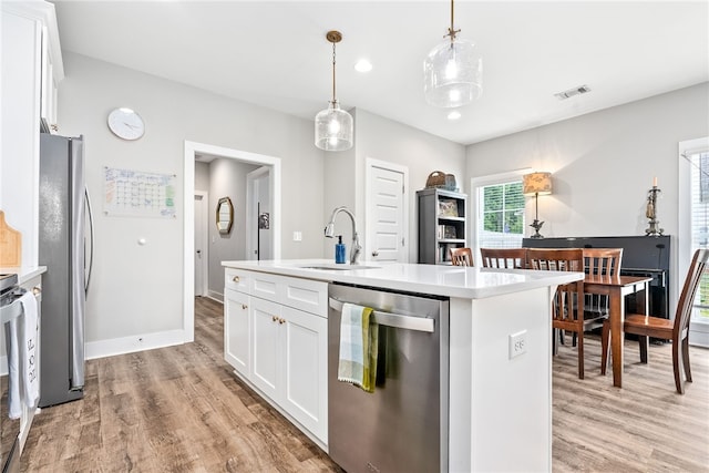 1242 Burrow Cir, Opelika, AL 36801 - kitchen with stainless steel appliances, light wood finished floors, white cabinets, light countertops, and recessed lighting