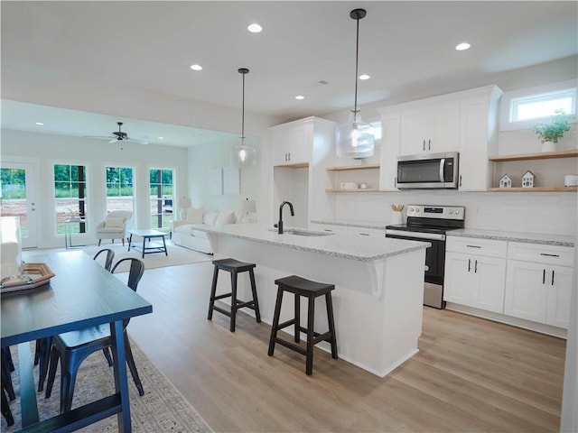 1003 Crossing Ct E, Valley, AL 36854 - kitchen with appliances with stainless steel finishes, open shelves, open floor plan, healthy amount of natural light, and recessed lighting