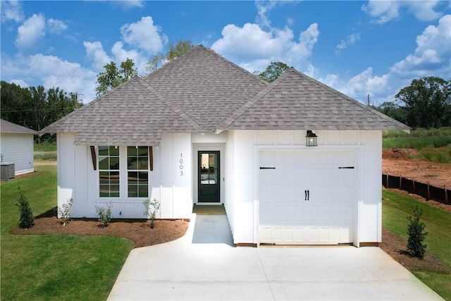 1003 Crossing Ct E, Valley, AL 36854 - view of front of property with roof with shingles, concrete driveway, board and batten siding, and a garage