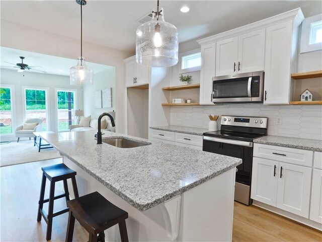 1003 Crossing Ct E, Valley, AL 36854 - kitchen with open shelves, appliances with stainless steel finishes, open floor plan, light wood-type flooring, and healthy amount of natural light