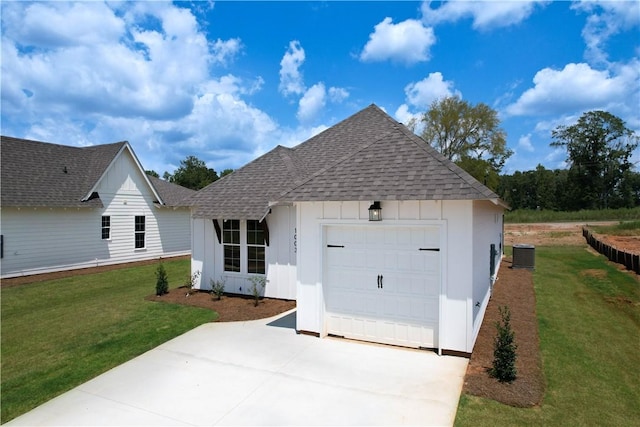 1003 Crossing Ct E, Valley, AL 36854 - view of front of house with concrete driveway, a shingled roof, board and batten siding, a front yard, and a garage