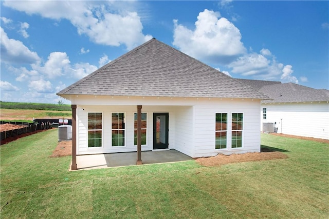 1003 Crossing Ct E, Valley, AL 36854 - back of property featuring a shingled roof, a patio, and a lawn