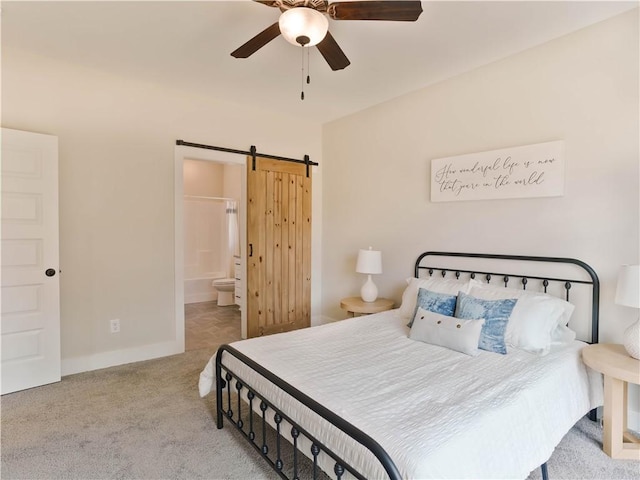 1003 Crossing Ct E, Valley, AL 36854 - carpeted bedroom featuring a barn door, ensuite bathroom, and ceiling fan
