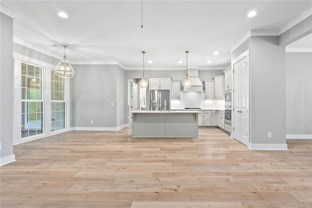 kitchen with custom exhaust hood, tasteful backsplash, open floor plan, light countertops, and appliances with stainless steel finishes