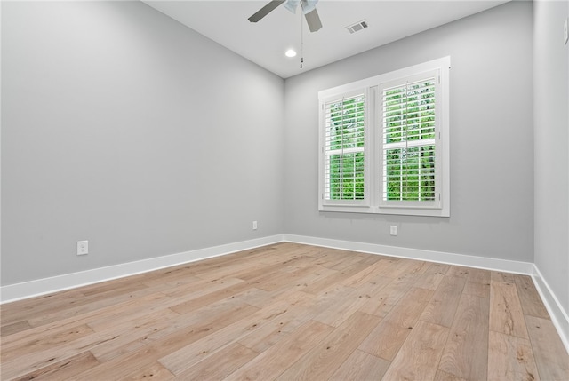 unfurnished room with visible vents, baseboards, a ceiling fan, and light wood-style flooring