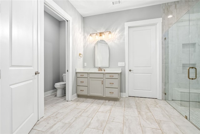 full bathroom featuring toilet, a stall shower, and marble finish floor