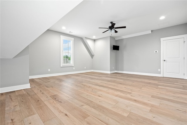 additional living space with light wood-style floors, baseboards, and a ceiling fan