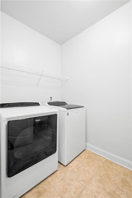 2711 Tara Ct, Opelika, AL 36804 - laundry area with separate washer and dryer and light tile patterned floors