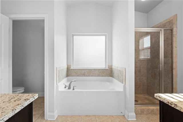 2711 Tara Ct, Opelika, AL 36804 - bathroom with vanity, a shower stall, a garden tub, and healthy amount of natural light