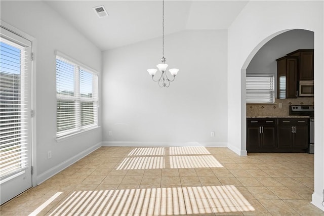 2711 Tara Ct, Opelika, AL 36804 - unfurnished dining area with lofted ceiling, light tile patterned floors, a chandelier, and arched walkways