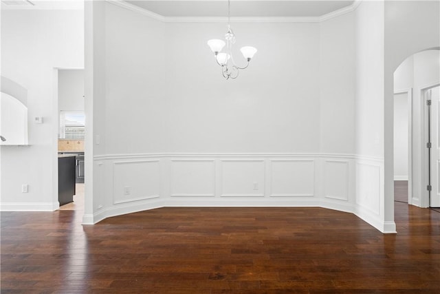 2711 Tara Ct, Opelika, AL 36804 - unfurnished dining area featuring a chandelier, a towering ceiling, wood finished floors, arched walkways, and ornamental molding