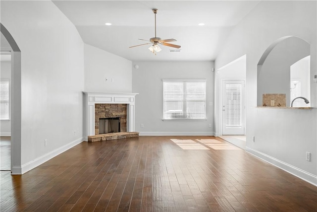 2711 Tara Ct, Opelika, AL 36804 - unfurnished living room featuring lofted ceiling, a ceiling fan, hardwood / wood-style flooring, and a fireplace